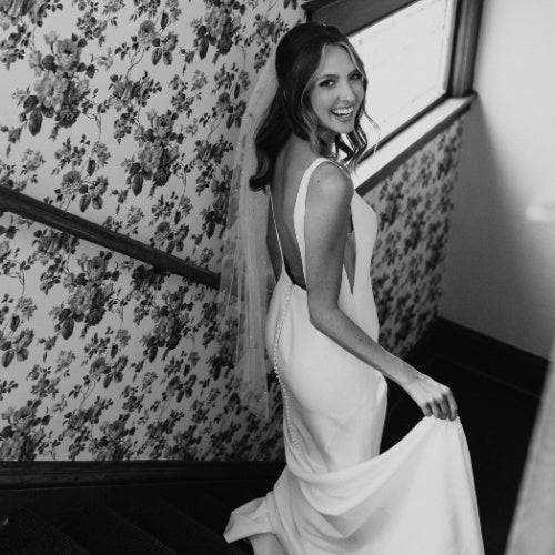 bride walks down the stairs at Wedding Shoppe in St. Paul, Minnesota